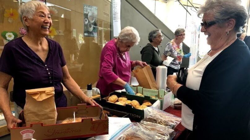 seniors at Trout Lake smiling, hosting a bake sale