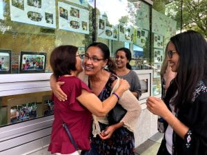 Former teacher Lucy hugs Head Teacher Sunny as teachers Audrey and Nayomi wait their turn!